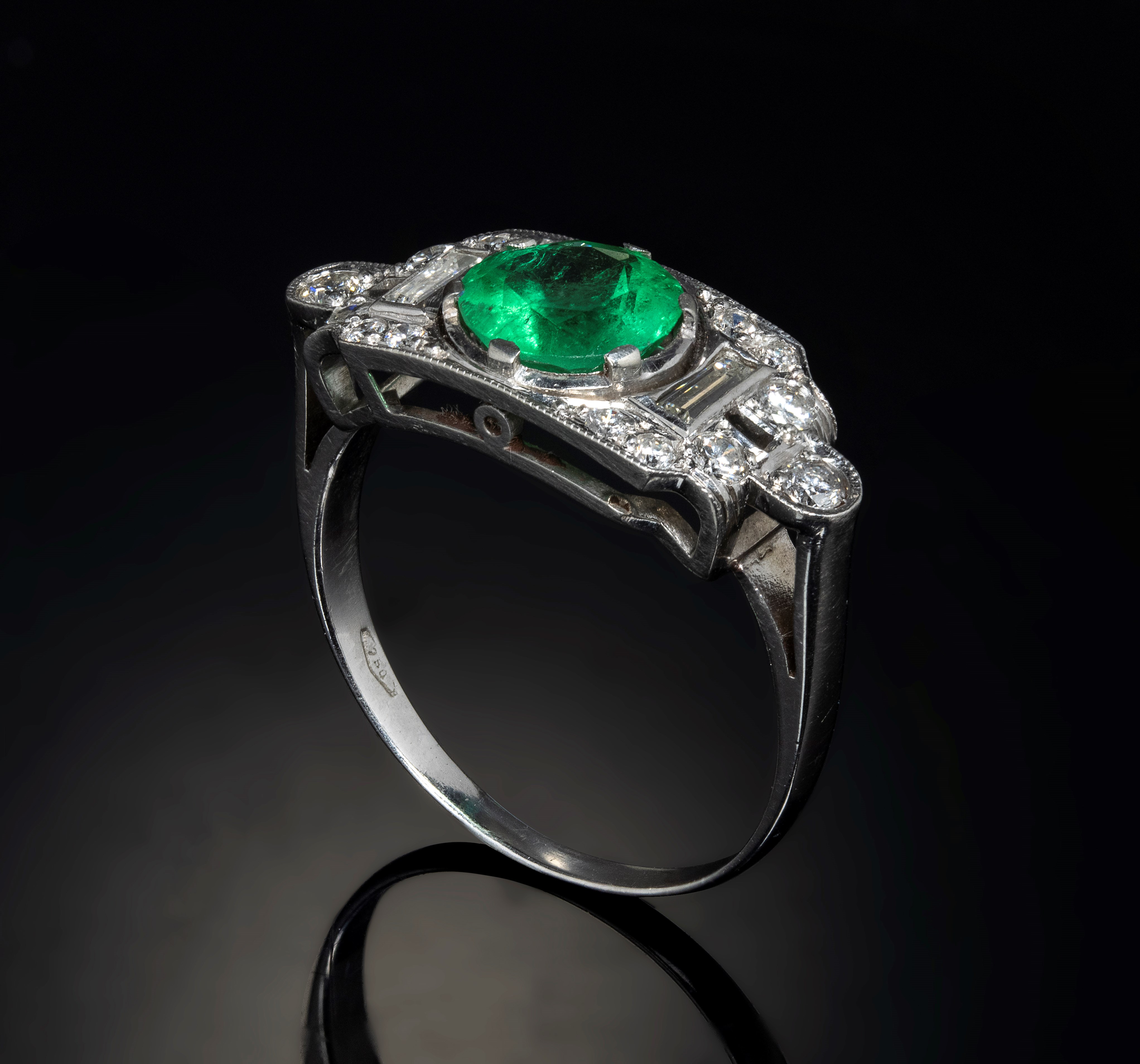 A 1940 platinum ring with diamonds and emerald.